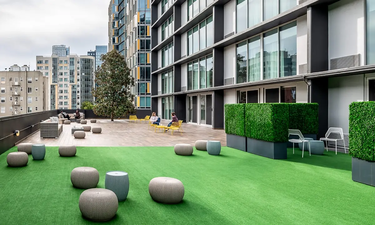 Group of people doing yoga on rooftop terrace
